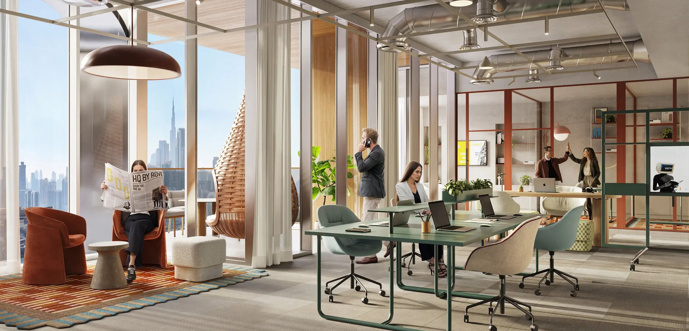 An office lounge with a red-framed shelving wall, open desks and floor-to-ceiling glazing