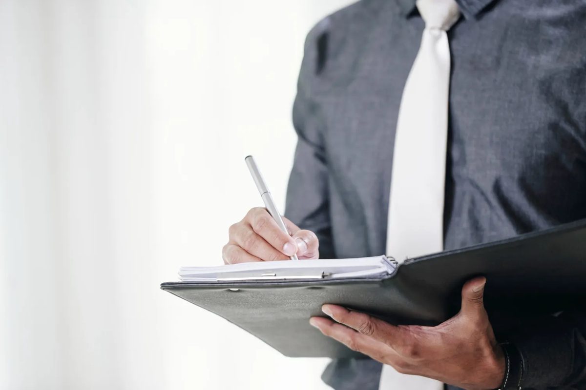 Consultant taking notes on a clipboard