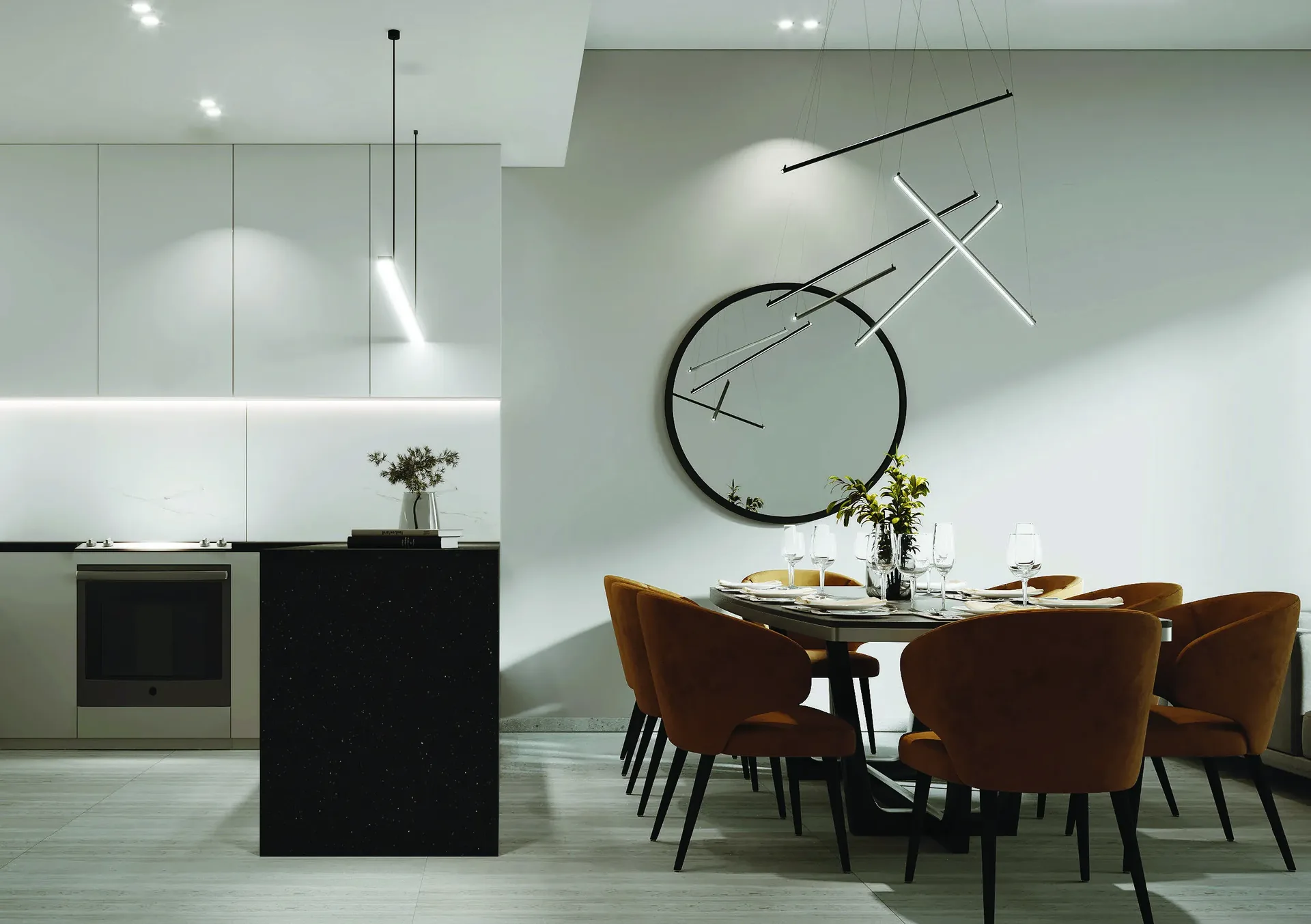 Kitchen and dining area with a dark stone island, white cabinetry and caramel dining chairs
