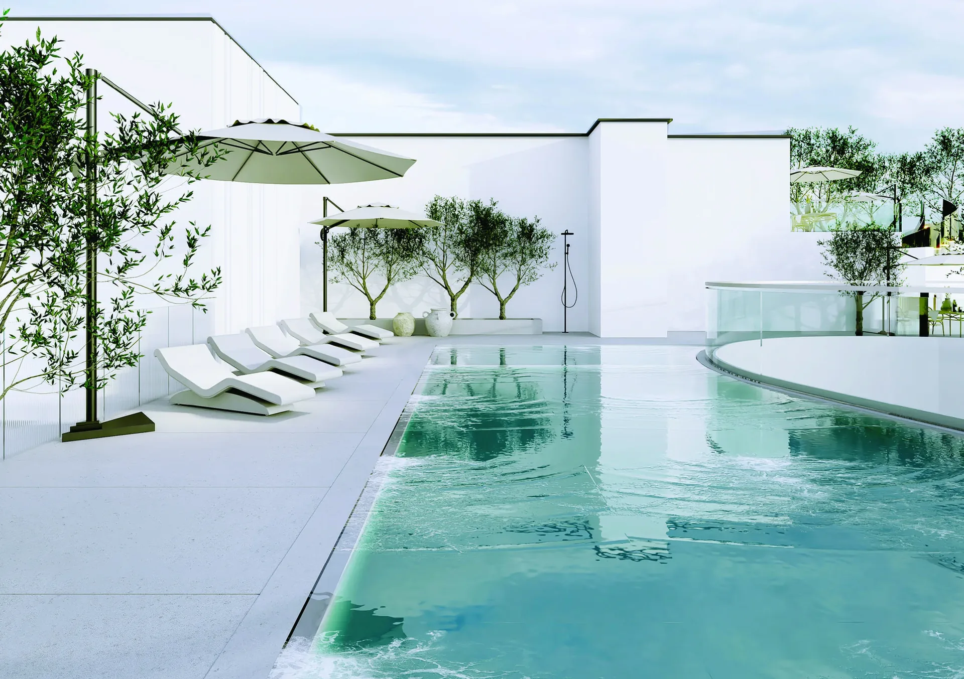 Rooftop swimming pool with sun loungers, parasols and olive trees on the twelfth-floor terrace