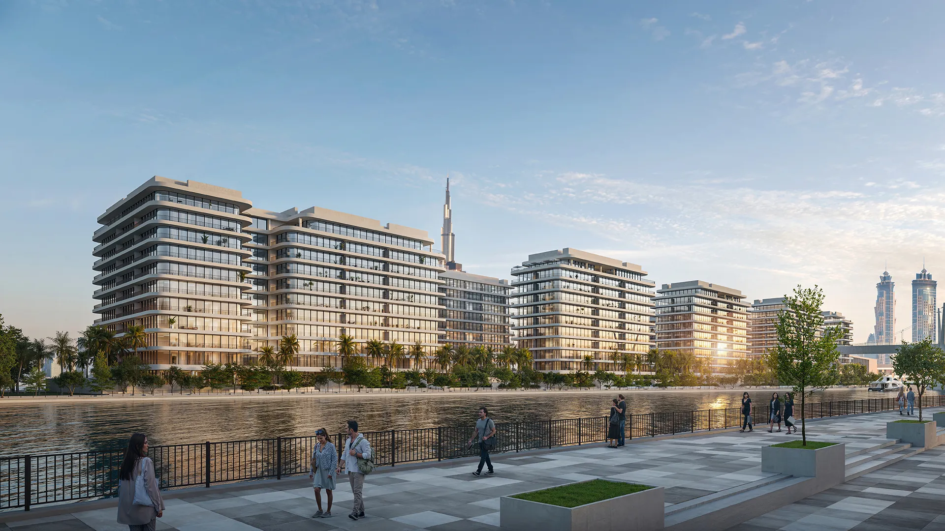The seven low-rise buildings of Eden House The Park seen across the Dubai Water Canal at sunset