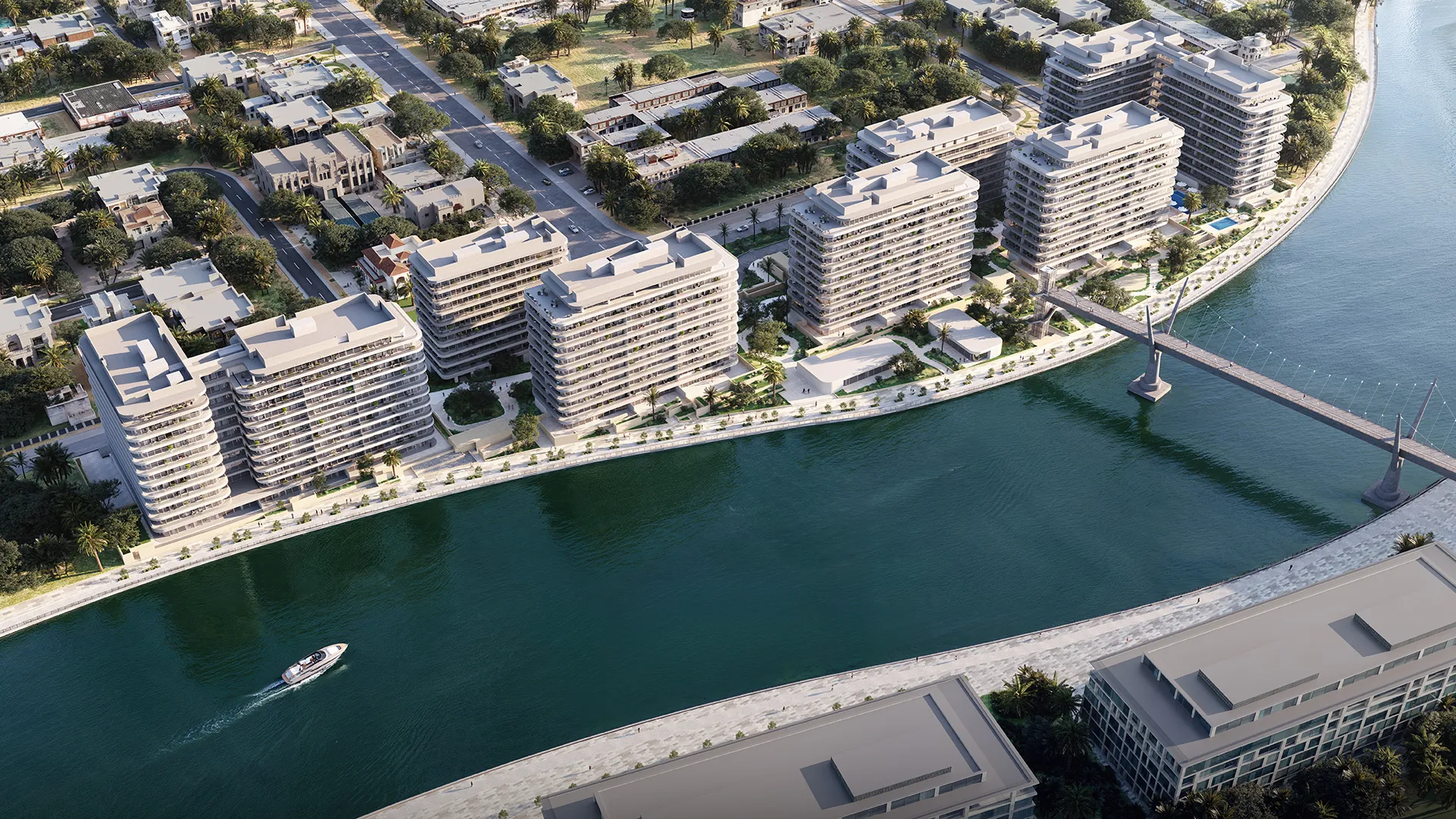 Aerial view of the seven low-rise buildings of Eden House The Park on a bend of the Dubai Water Canal, the footbridge beyond
