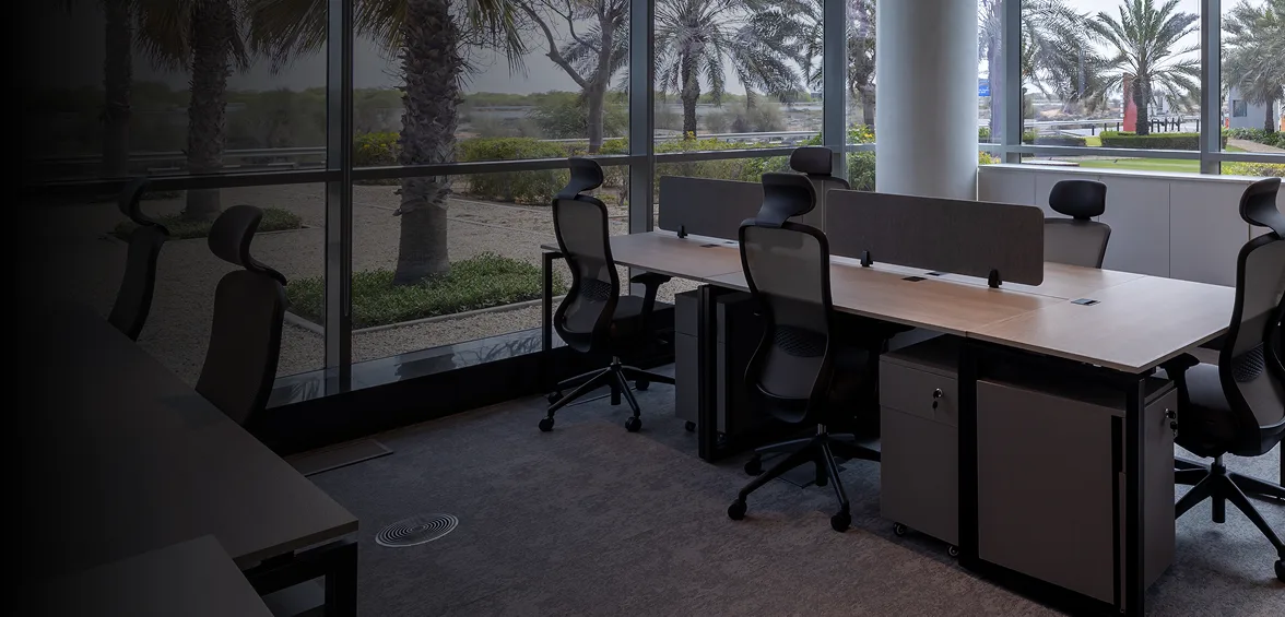 Desks and chairs at Innovation City HQ looking out over palm trees