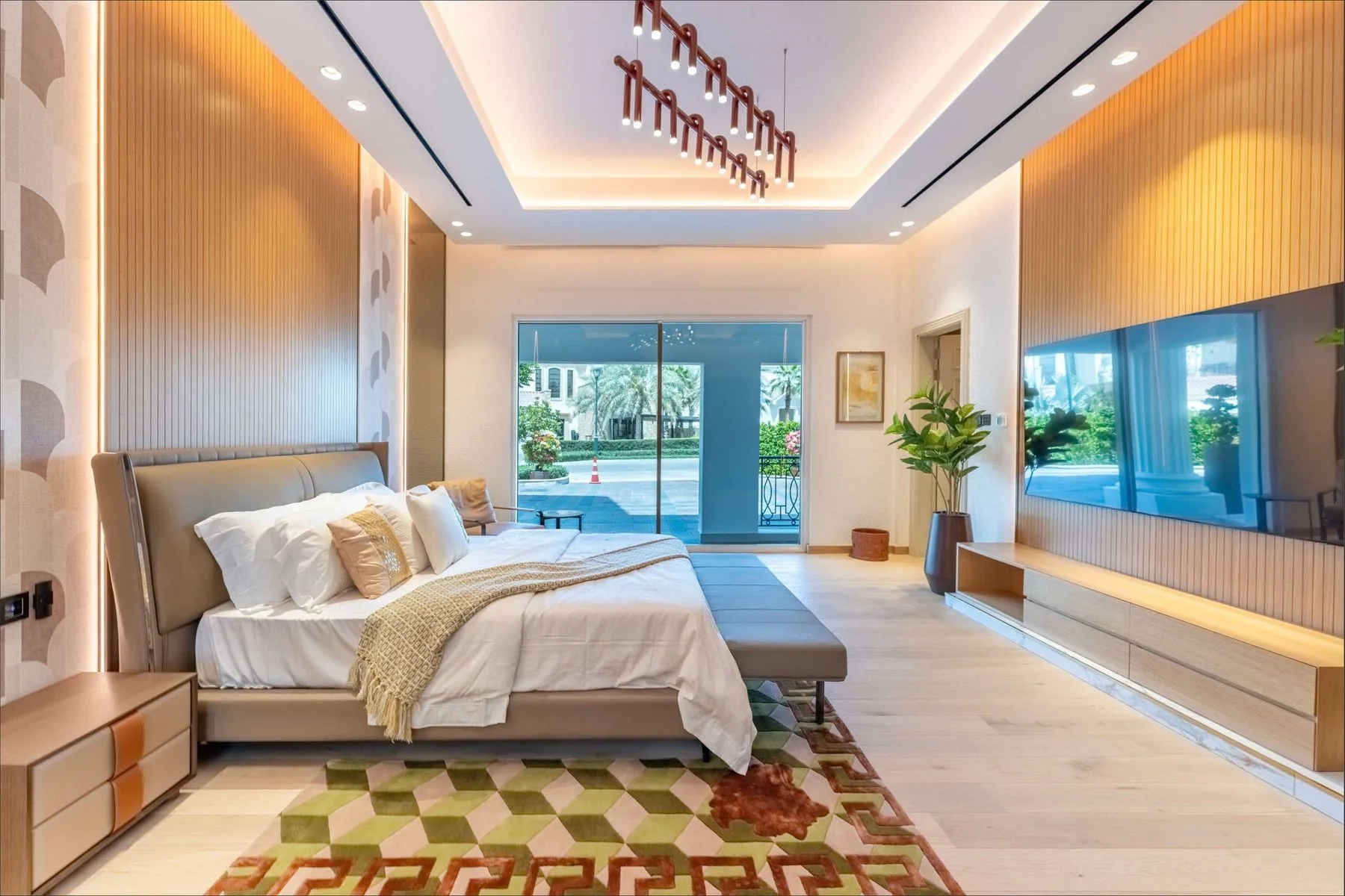 A bedroom with timber panelling and glazing onto the courtyard pool