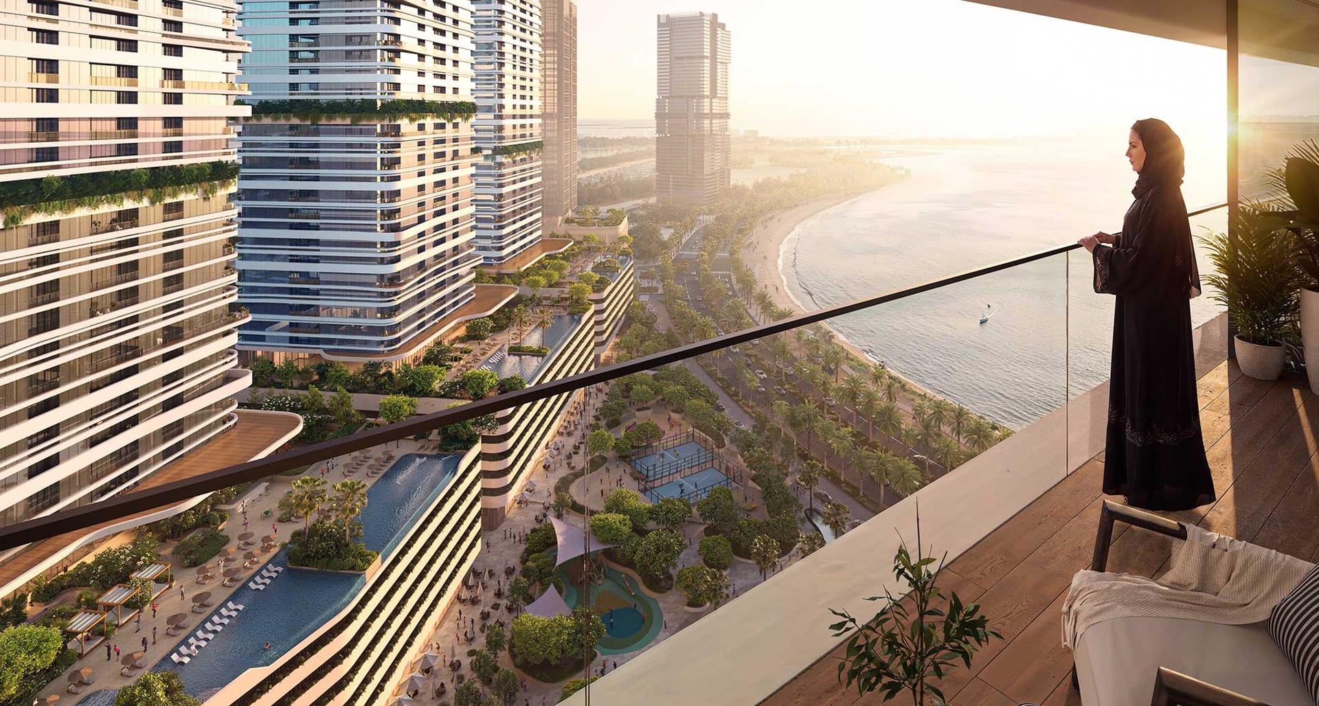 A resident on her balcony above Al Mamzar beach at sunset