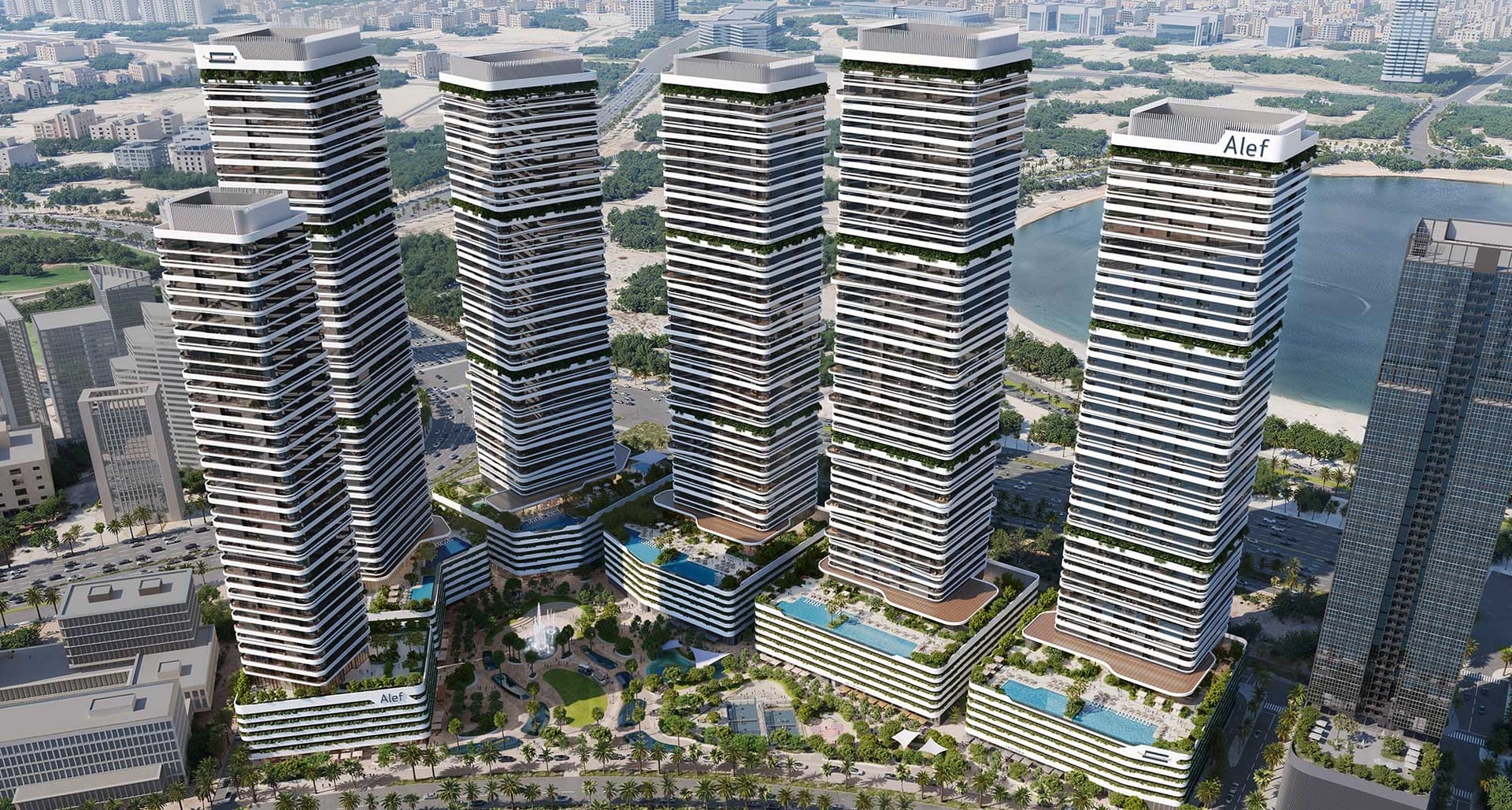 Daytime aerial of the six towers with the Sharjah coastline beyond