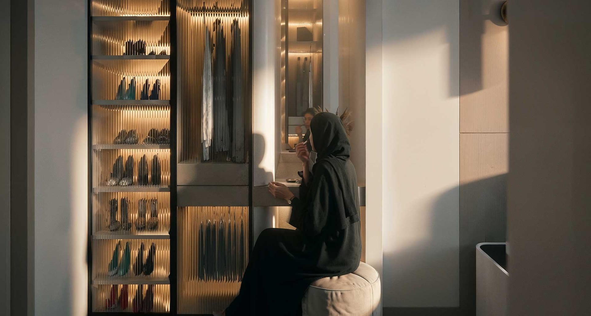 Walk-in wardrobe with lit shelving