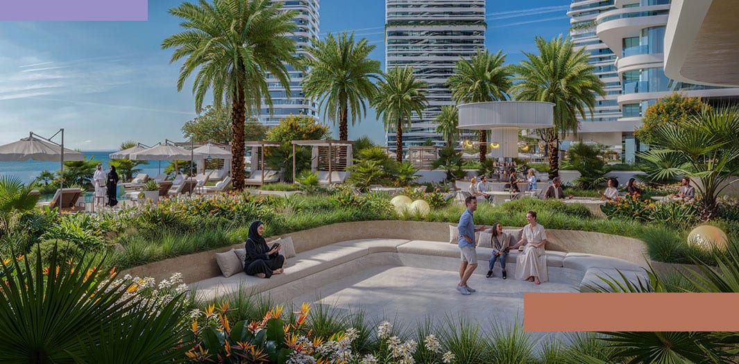 Landscaped central plaza between the towers at Linar, with residents walking under palms