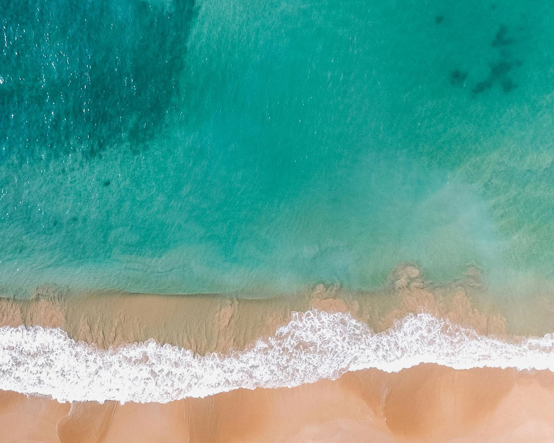 Turquoise water and sand at Mamsha Beach, from above