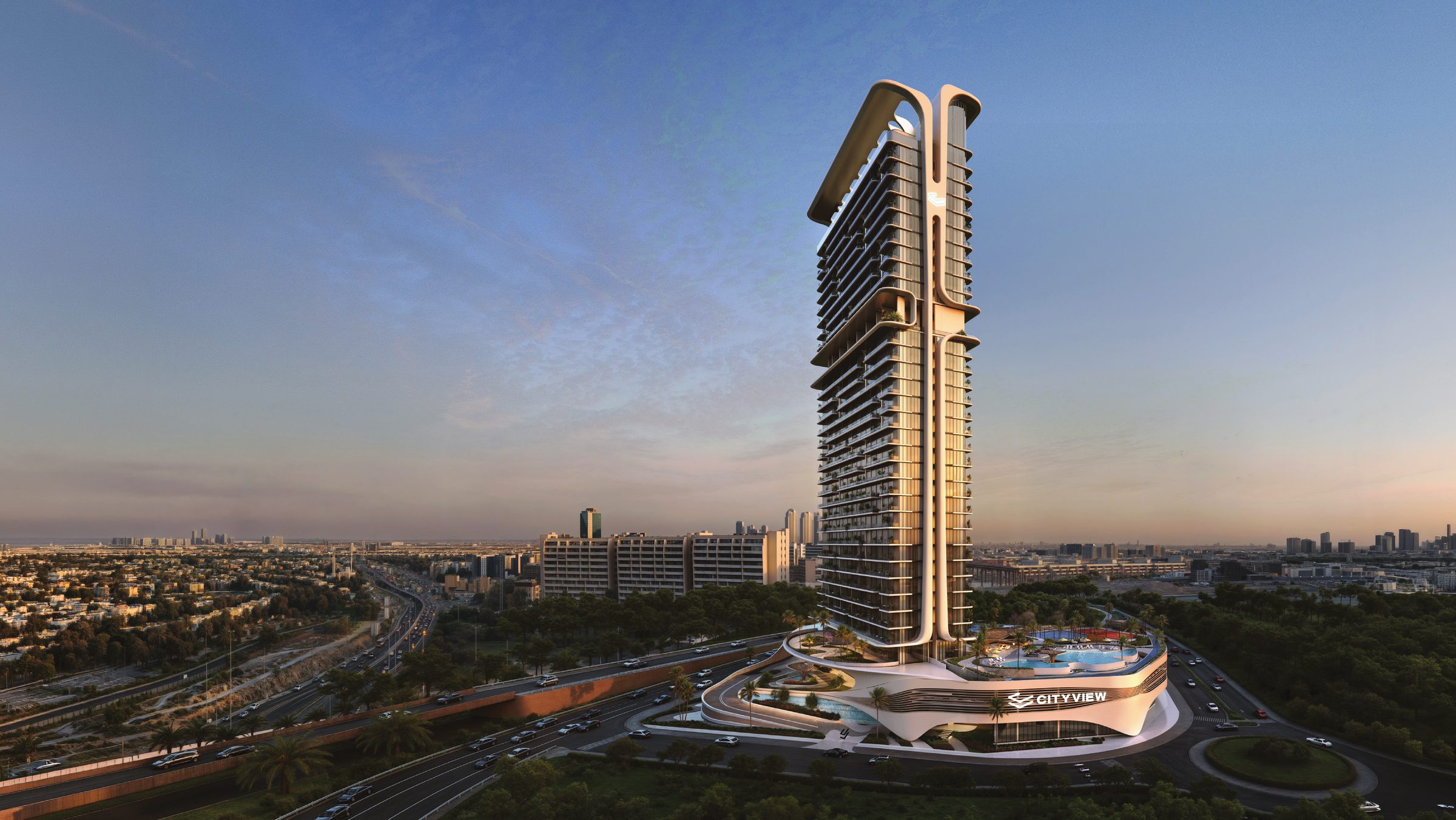 Mövenpick Residences Dubai Motor City tower at dusk, seen across the landscaped podium